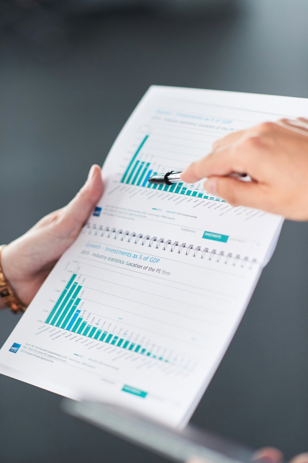 A printed results chart held open in both hands